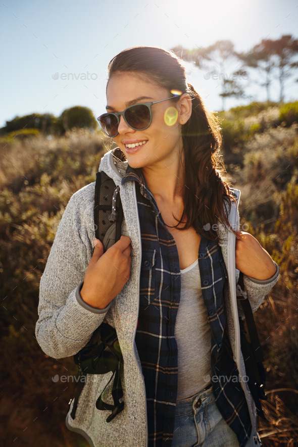 Happy young woman hiking on a sunny day - Stock Photo - Images