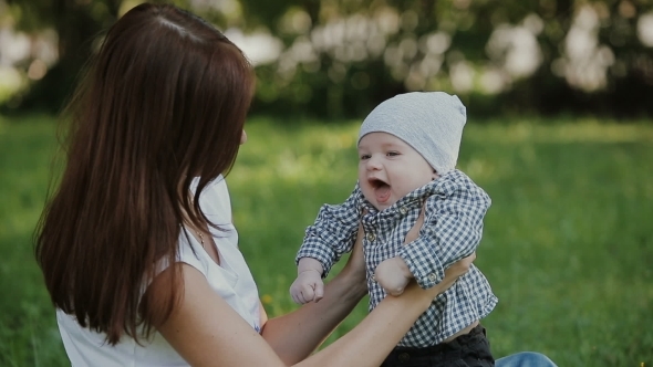 Happy Baby Boy Playing With Mother In The Park Happy Baby Boy Playing With Mother In The Park