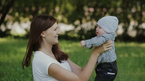 Happy Baby Boy Playing With Mother In The Park Happy Baby Boy Playing With Mother In The Park