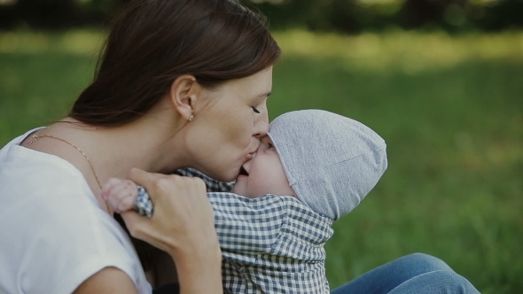 Happy Baby Boy Playing With Mother In The Park Happy Baby Boy Playing With Mother In The Park