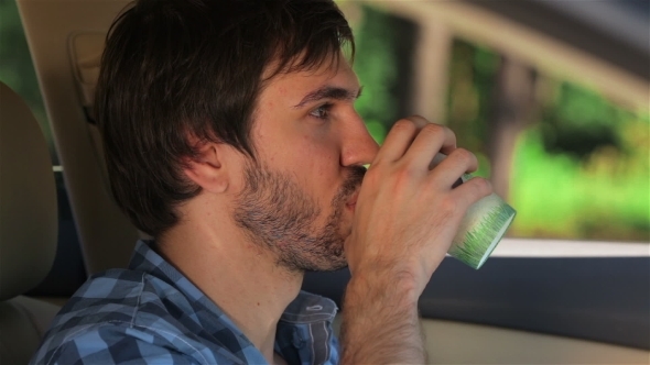 Man Drinking Coffee In The Parked Car alt