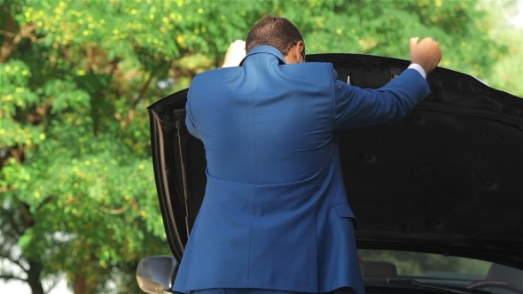The Businessman Raised The Hood Of His Car The Businessman Raised The Hood Of His Car