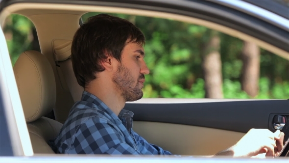 The Guy Sitting In The Car Running On The Tablet The Guy Sitting In The Car Running On The Tablet