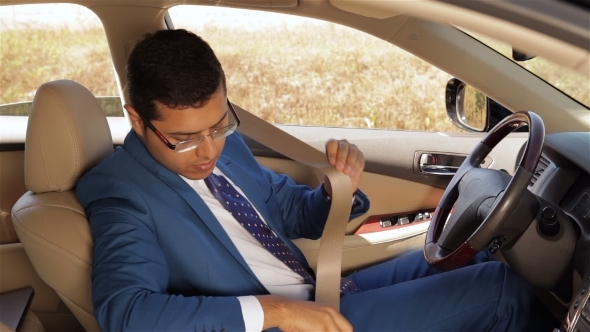 Businessman Wear a Seatbelt And Gets Under Way Businessman Wear a Seatbelt And Gets Under Way