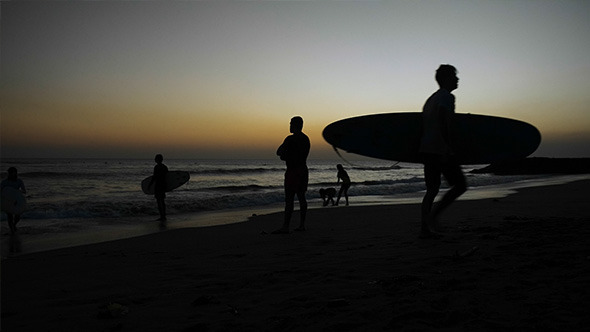 Surfers on the Beach after Sunset Surfers on the Beach after Sunset