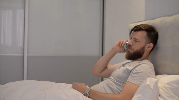 Man Talking on Smartphone in Bed Man Talking on Smartphone in Bed