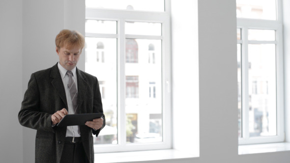 Businessman Typing on Tablet Businessman Typing on Tablet