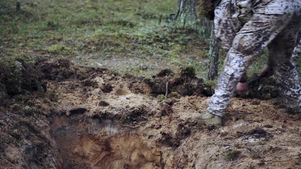 One Soldier Digs a Trench in a Pine Forest alt