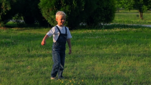 Elementary Aged Boy Kicking Ball In The Field Elementary Aged Boy Kicking Ball In The Field