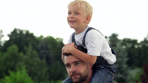Happy Father With His Baby Son On His Neck Happy Father With His Baby Son On His Neck
