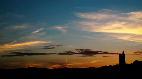 Sunset Sky, Clouds over Lighthouse on Coast. Timelapse alt
