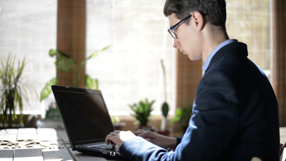 Young Freelancer Working on Laptop Young Freelancer Working on Laptop