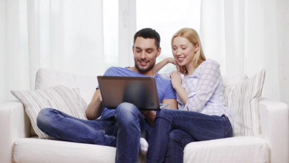Happy Couple With Laptop Computer At Home Happy Couple With Laptop Computer At Home