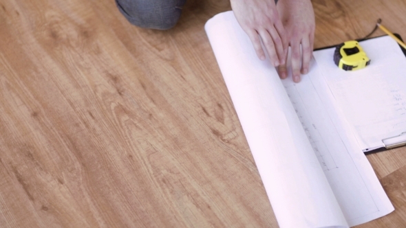 Male Hands With Measuring Tape And Blueprint Male Hands With Measuring Tape And Blueprint