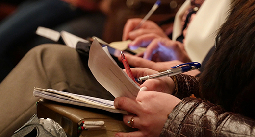 College Student Taking Notes While Studying