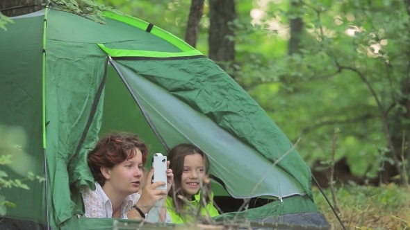 Girls And Boy Admire The Nature Lying In Tent.
