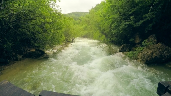 Rough Mountain River Flowing Down In Lush Green