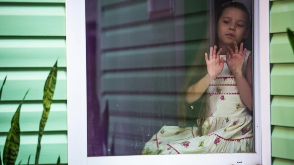 Sad Girl Sitting At Window And Looking At Rain