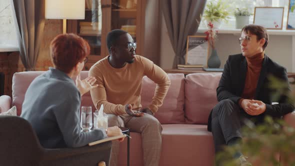 Gay Coupe Having Therapy Session with Psychologist alt