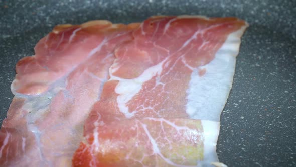 Slices of Bacon Lays on Hot Grill