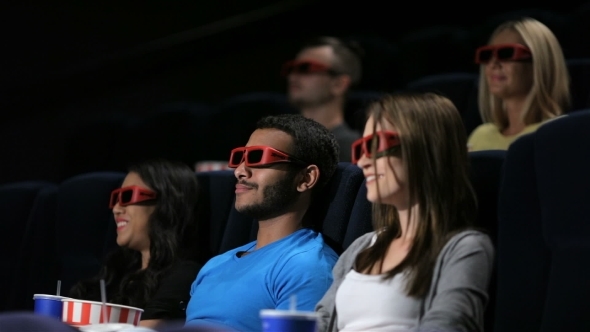 Group Of Friends Watching Film In Cinema Group Of Friends Watching Film In Cinema