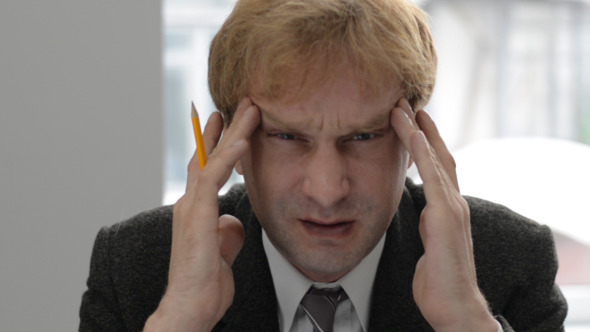 Man with Headache in Office Man with Headache in Office