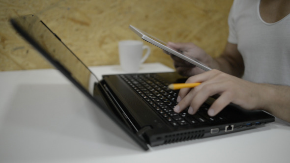 Casual Businessman Working with Laptop and Tablet Casual Businessman Working with Laptop and Tablet