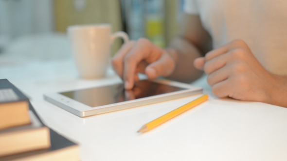 Man Using Tablet on Desk Man Using Tablet on Desk