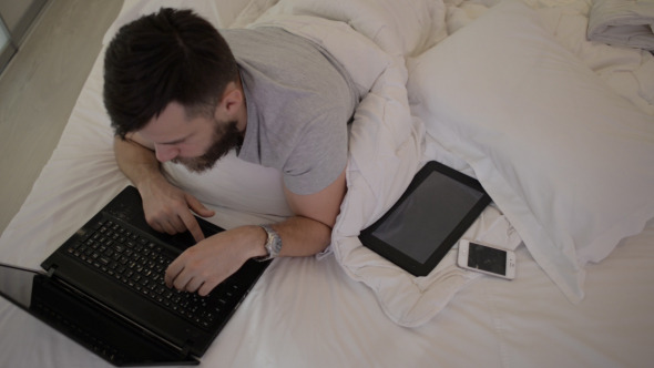 Beard Man Using Laptop in Bed 2 Beard Man Using Laptop in Bed 2
