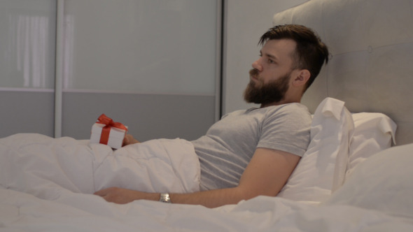 Man Thinking Gift in Hand Man Thinking Gift in Hand