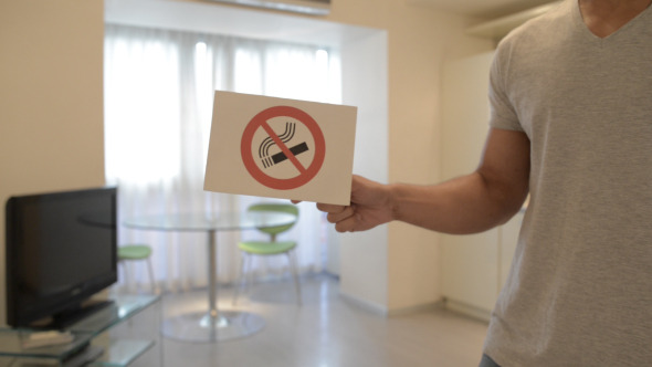 No Smoking Sign by Man in House No Smoking Sign by Man in House