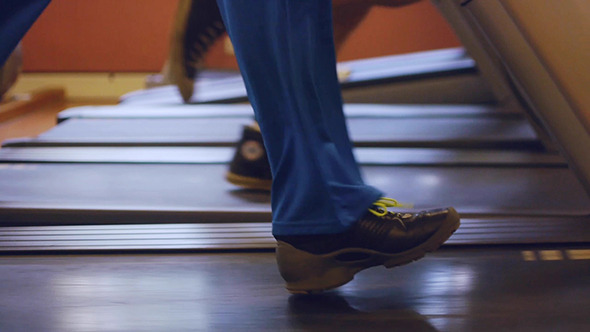 People Jogging On A Treadmill In The Gym People Jogging On A Treadmill In The Gym