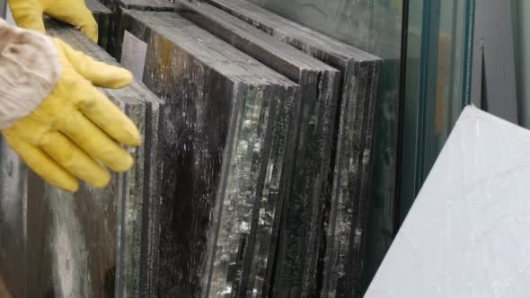 Hands in Yellow Gloves Touch The Glass Sheets Hands in Yellow Gloves Touch The Glass Sheets