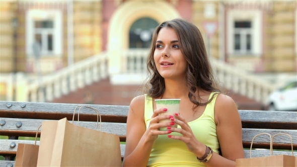 The Girl Sitting On a Bench Drinking Coffee The Girl Sitting On a Bench Drinking Coffee