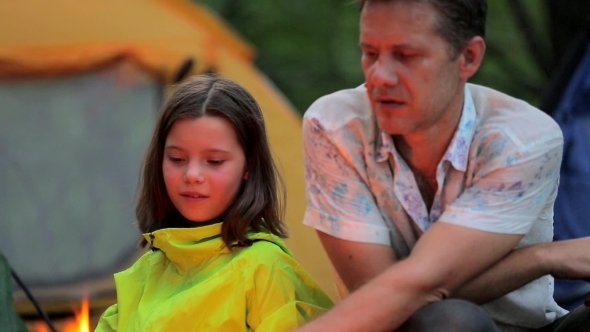 Late Evening In Camp, Father And Daughter Sitting