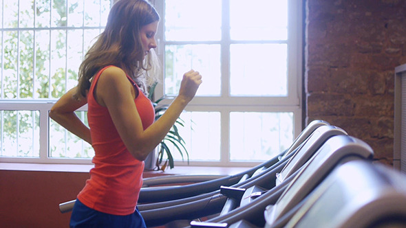 Young Woman Running On Treadmill