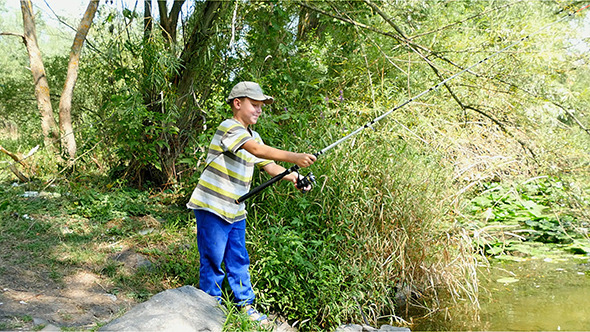 Boy Fishing With Spinning On The River Boy Fishing With Spinning On The River