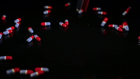 Pills Capsules Falling Onto Black Glass 4