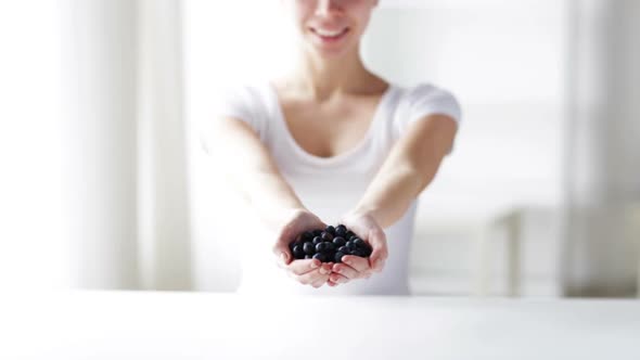 Close Up Of Young Woman Showing Blueberries 2 alt