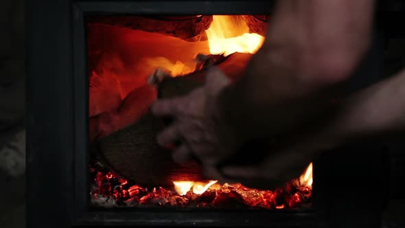 Man Putting Log Woods Inside A Fireplace
