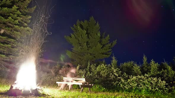 Stars Timelapse And Lonely Man In Front Of A Campfire