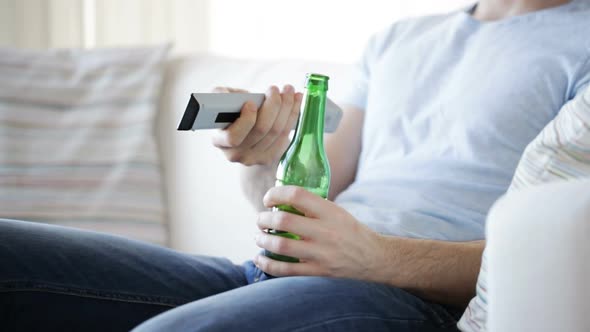 Close Up Of Man With Beer And Remote At Home 5 alt