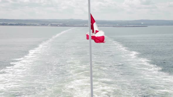 Canada Flag On Boat Leaving The Coast