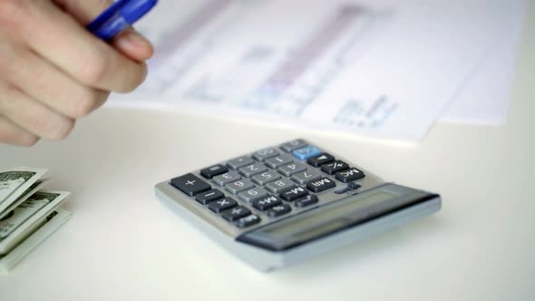 Close Up Of Man With Calculator Counting Money 5 alt