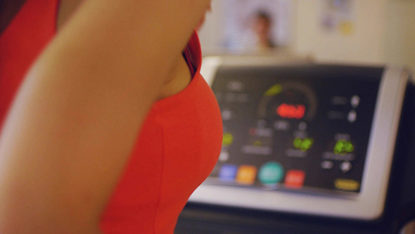 Rear View Of Female Running On Treadmill In Gym Rear View Of Female Running On Treadmill In Gym