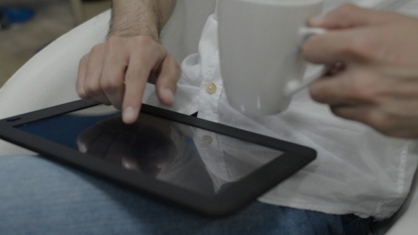 Casually Using Digital Tablet in Lap 2 Casually Using Digital Tablet in Lap 2