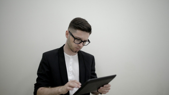 Serious Young Man Using on TAblet Serious Young Man Using on TAblet