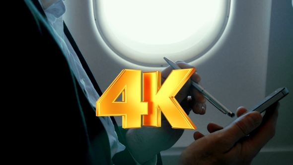Businessman Using Smart Phone During The Flight Businessman Using Smart Phone During The Flight
