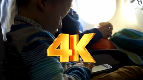 Little Child In Plane Using Smartphone Little Child In Plane Using Smartphone