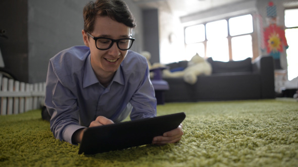 Man Face Reaction while Using Tablet alt